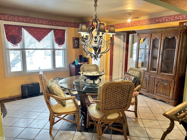 dining area featuring a notable chandelier and light tile patterned floors