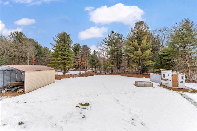 yard layered in snow with an outdoor structure