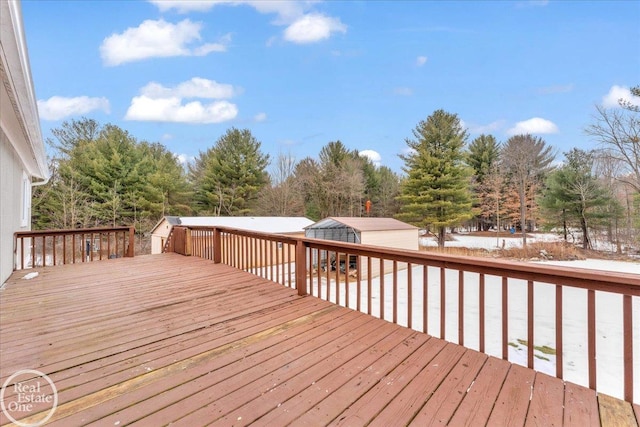 wooden deck featuring an outdoor structure and a storage shed