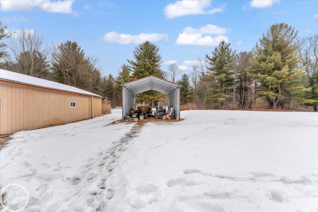 snowy yard with a detached carport