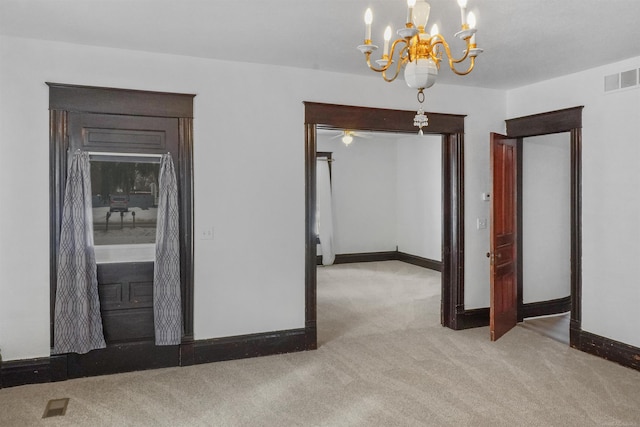 empty room with light carpet, visible vents, and baseboards