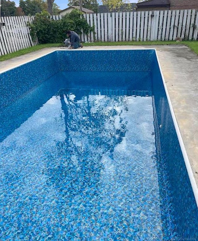 view of pool with a fenced backyard