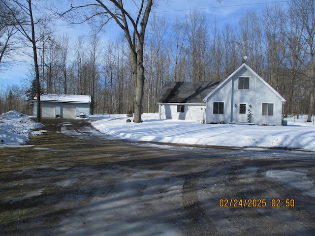 view of front of house featuring a detached garage and an outdoor structure