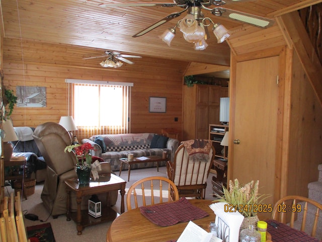 dining area with vaulted ceiling, carpet flooring, wood ceiling, and wooden walls