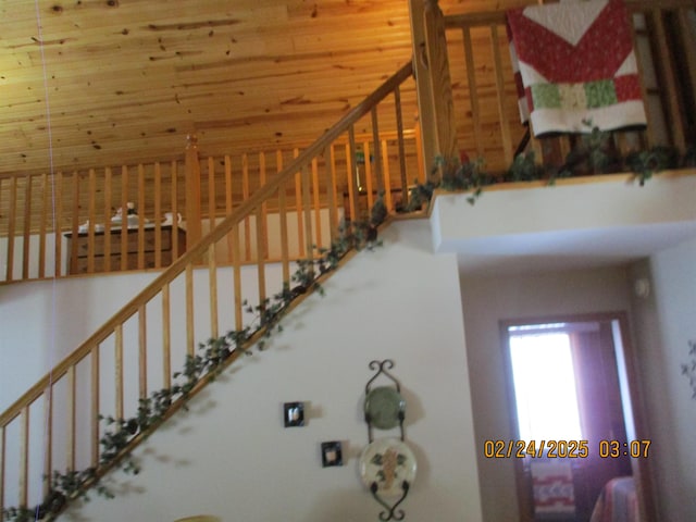 stairway featuring a towering ceiling