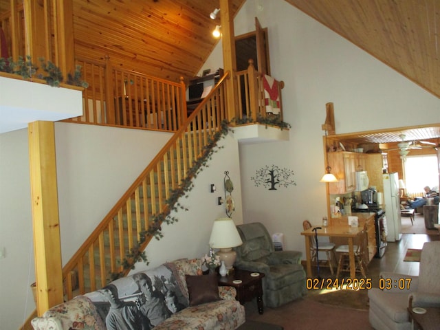 living room featuring wooden ceiling, stairway, and high vaulted ceiling