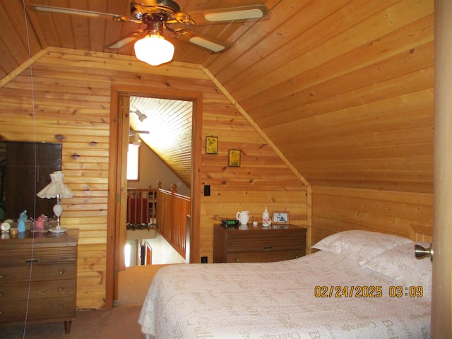 bedroom featuring lofted ceiling, wooden ceiling, and wooden walls