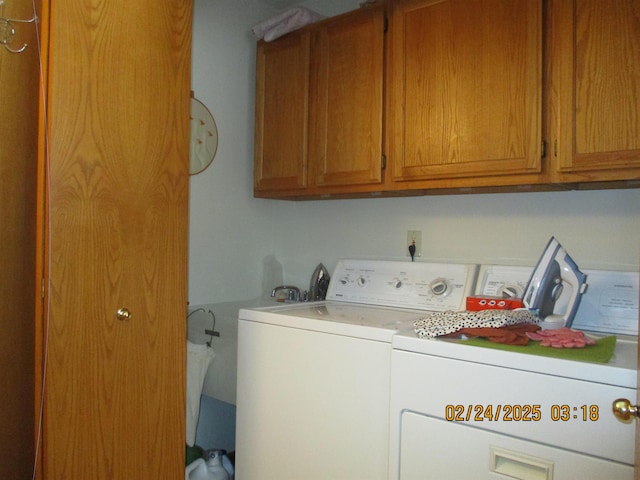 laundry room with washing machine and dryer and cabinet space