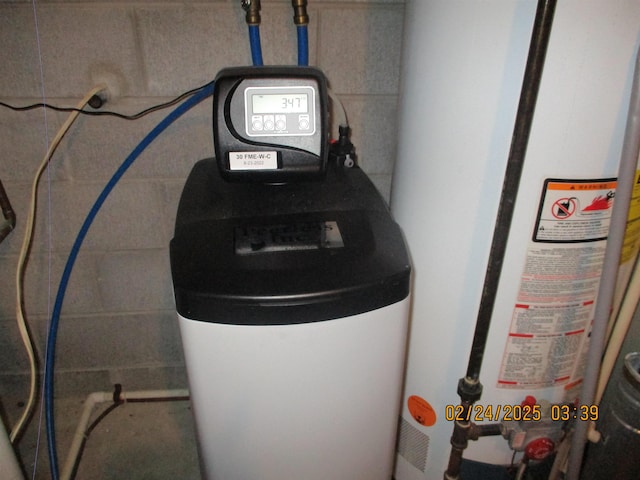 utility room with gas water heater