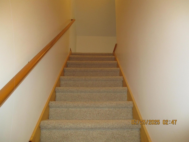 staircase featuring baseboards