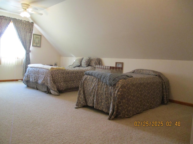 carpeted bedroom with lofted ceiling, ceiling fan, and baseboards