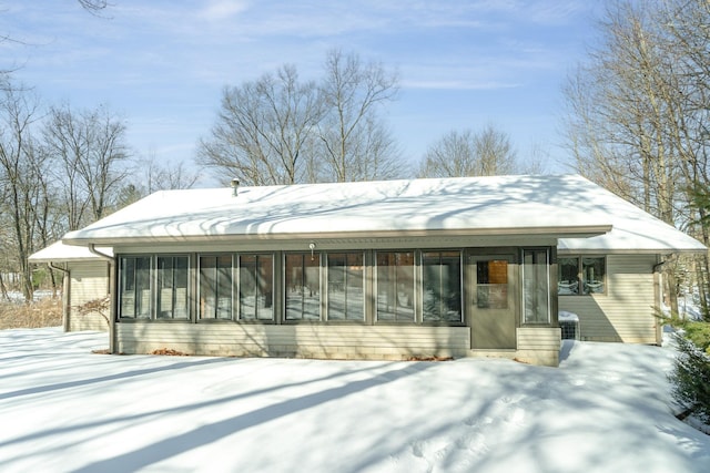 view of front of house featuring a sunroom and cooling unit