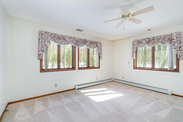 empty room with light colored carpet, visible vents, plenty of natural light, and baseboards