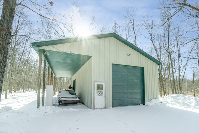 snow covered garage featuring a garage