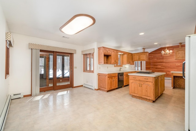 kitchen featuring black dishwasher, light floors, light countertops, freestanding refrigerator, and a kitchen island