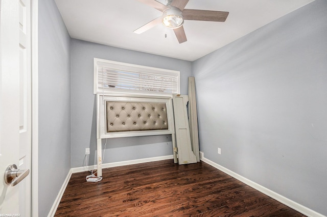 unfurnished bedroom with a ceiling fan, dark wood finished floors, and baseboards