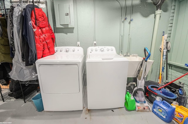 clothes washing area featuring separate washer and dryer and electric panel