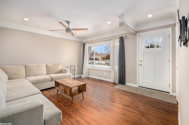 living room featuring dark wood-style floors, recessed lighting, and baseboards