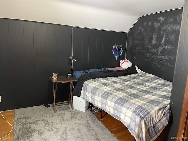 bedroom featuring vaulted ceiling and light wood finished floors