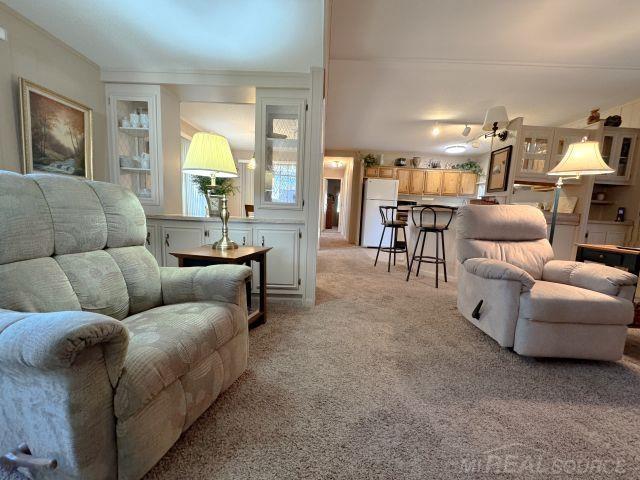 living area with light colored carpet