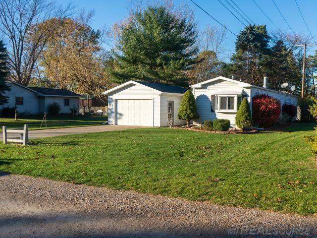 exterior space with a garage, driveway, and a front yard