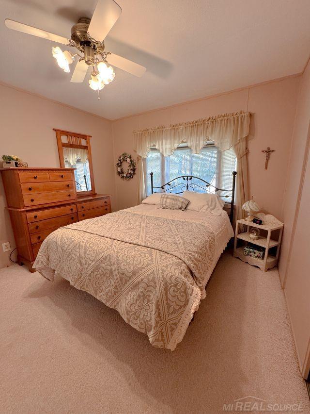 carpeted bedroom with ceiling fan