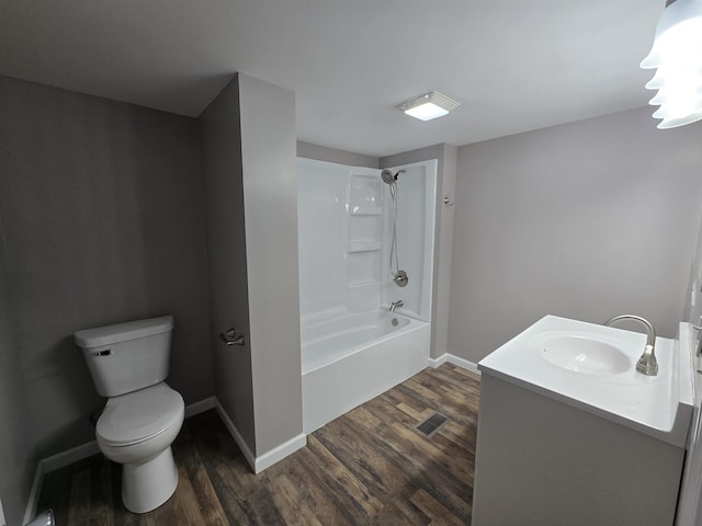 full bathroom featuring bathtub / shower combination, visible vents, toilet, wood finished floors, and baseboards