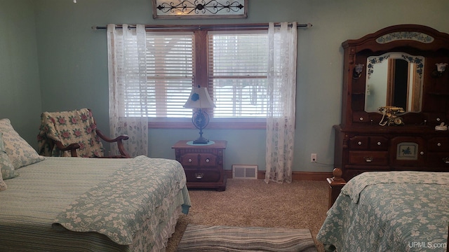 carpeted bedroom featuring visible vents