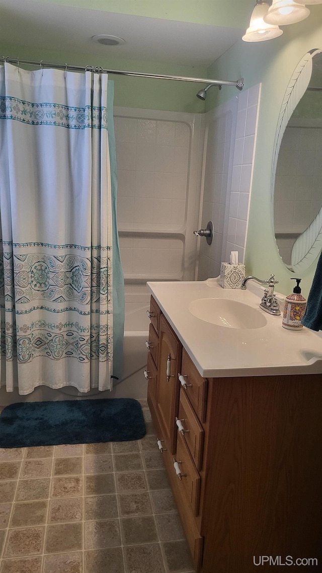 bathroom with shower / bath combo with shower curtain and vanity