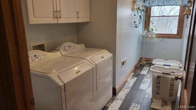 washroom featuring cabinet space, baseboards, visible vents, wood finished floors, and washer and dryer