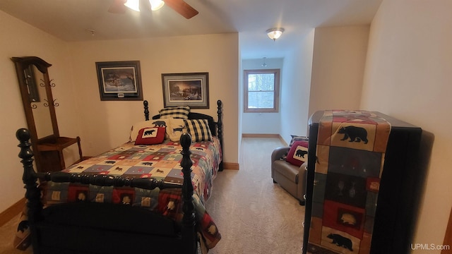 bedroom featuring light carpet, baseboards, and a ceiling fan