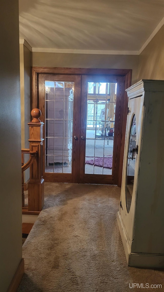 doorway with ornamental molding, carpet flooring, and french doors