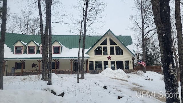 view of front facade with covered porch and metal roof