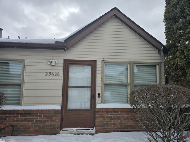 property entrance with brick siding