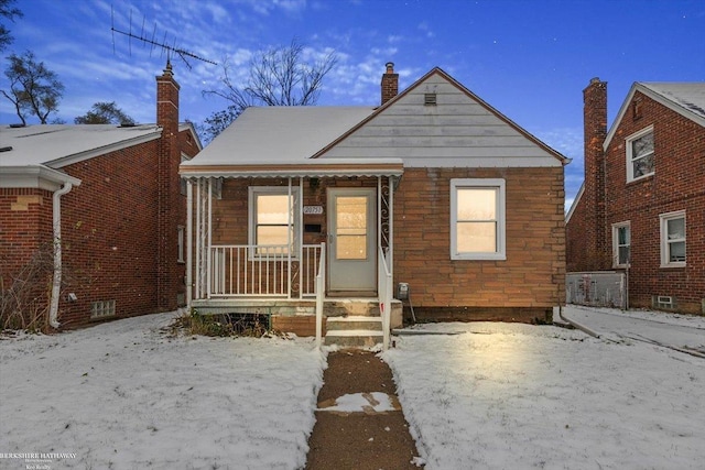 bungalow-style home featuring a porch and a chimney