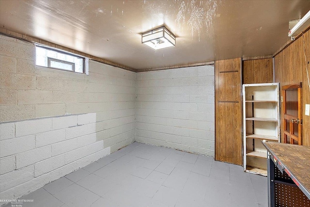 basement with concrete block wall and light floors