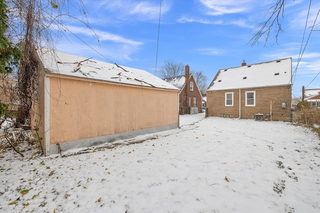 snowy yard featuring central AC unit