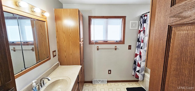 bathroom featuring plenty of natural light, visible vents, shower / bath combination with curtain, and tile patterned floors