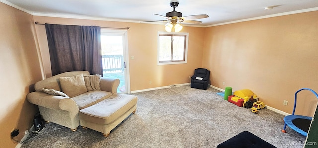 living area with a ceiling fan, baseboards, carpet flooring, and ornamental molding