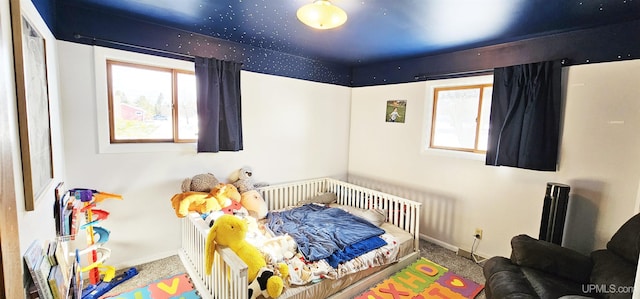 bedroom with carpet floors and baseboards