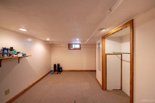 below grade area with recessed lighting, baseboards, and light colored carpet