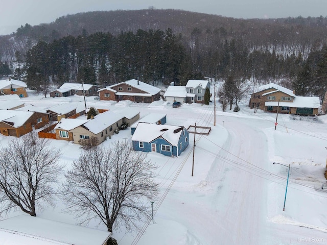 snowy aerial view with a view of trees