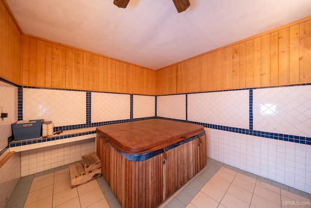 miscellaneous room featuring light tile patterned flooring and a hot tub