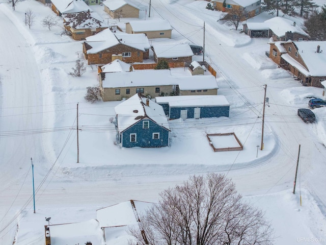 snowy aerial view with a residential view