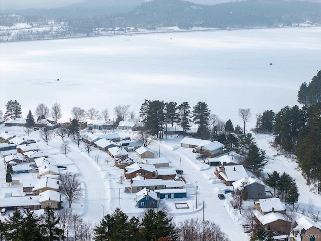 snowy aerial view with a residential view