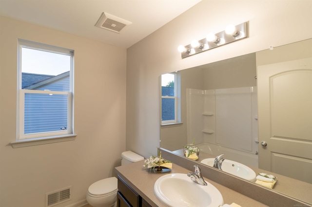 bathroom featuring a healthy amount of sunlight, visible vents, and toilet