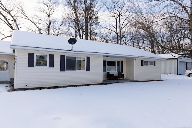 ranch-style home featuring an outbuilding