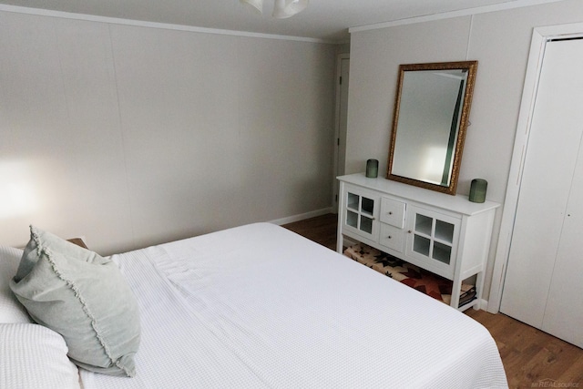 bedroom with ornamental molding and dark wood-type flooring