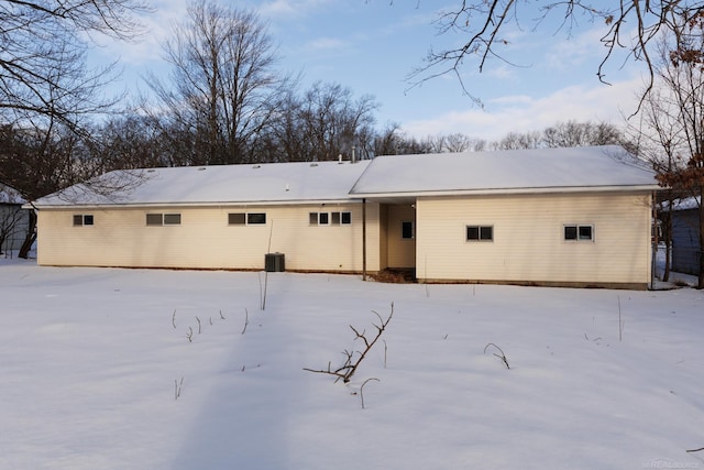 view of snow covered back of property