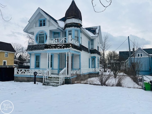 victorian home with covered porch and a balcony